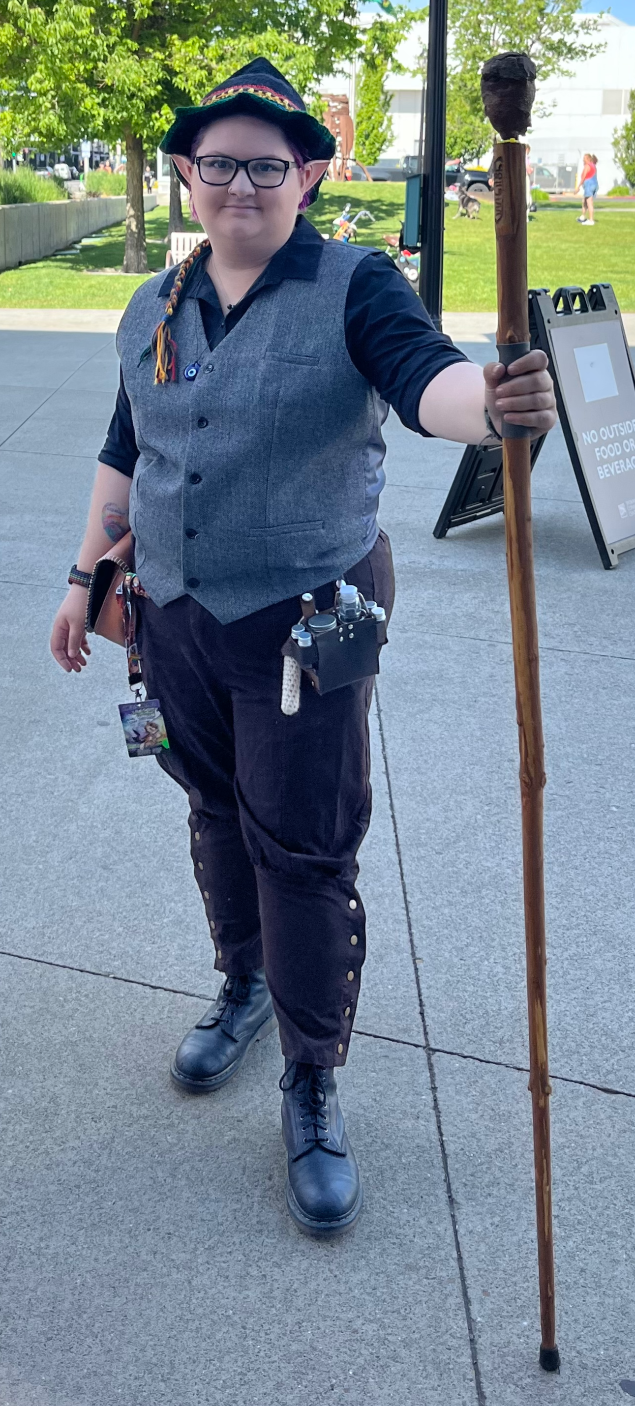 A picture of Emily Beer Standing outside in a city, wearing Renaissance Fair or Fantasy style clothing.